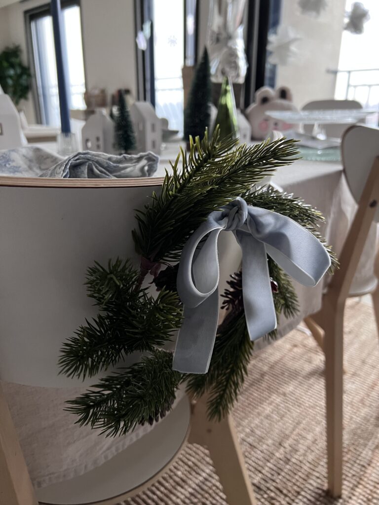 Wreaths from Arla's winter birthday brunch adorned with ice blue velvet bow. 