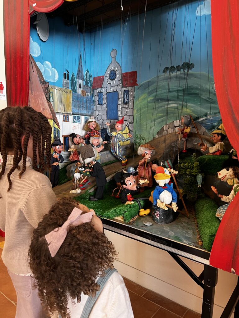 My daughters viewing the marionettes.